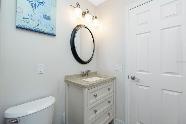 bathroom featuring toilet and vanity