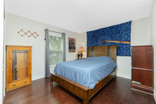 bedroom with dark wood-type flooring