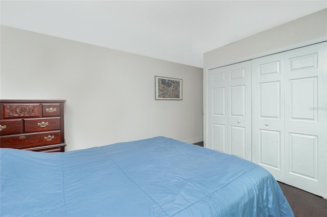 bedroom featuring a closet and dark hardwood / wood-style floors