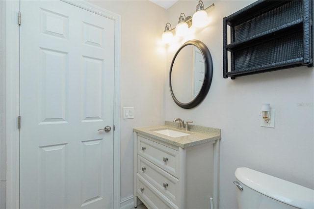 bathroom with toilet and vanity