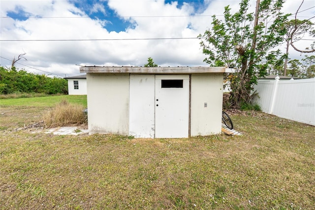 view of outbuilding with a yard