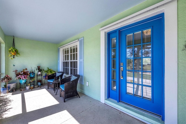 entrance to property featuring stucco siding