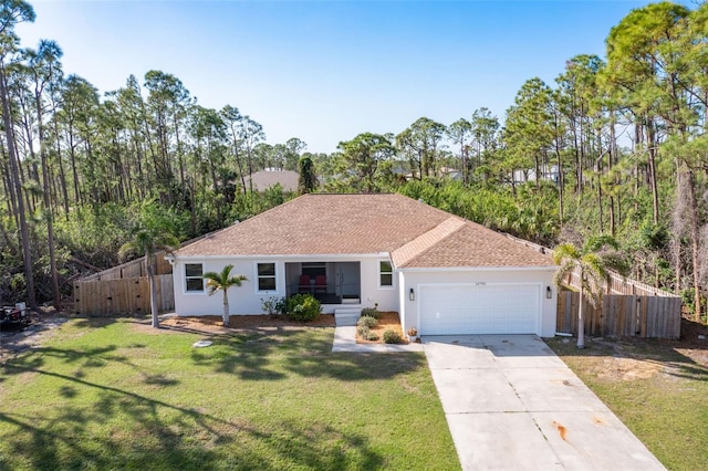 ranch-style home with fence, concrete driveway, and a front yard