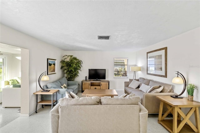 living room featuring a healthy amount of sunlight and a textured ceiling