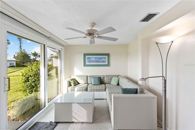 sunroom featuring ceiling fan