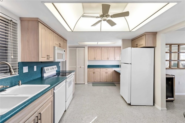 kitchen featuring light brown cabinetry, sink, white appliances, a skylight, and ceiling fan