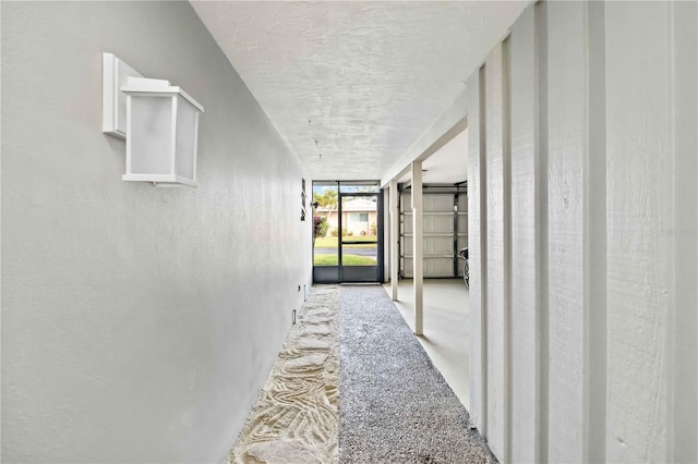 hallway featuring expansive windows and a textured ceiling