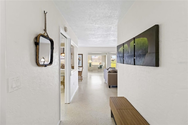 corridor with a textured ceiling