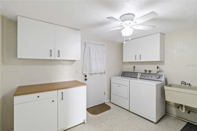 laundry room with cabinets, washer and dryer, sink, and ceiling fan