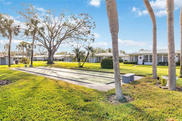 view of property's community with a lawn