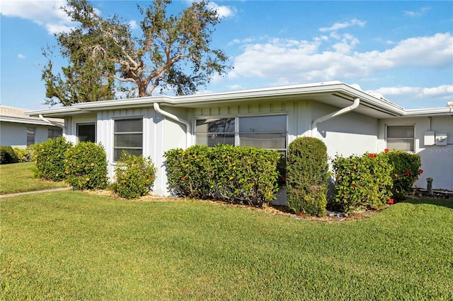 view of side of property with a lawn