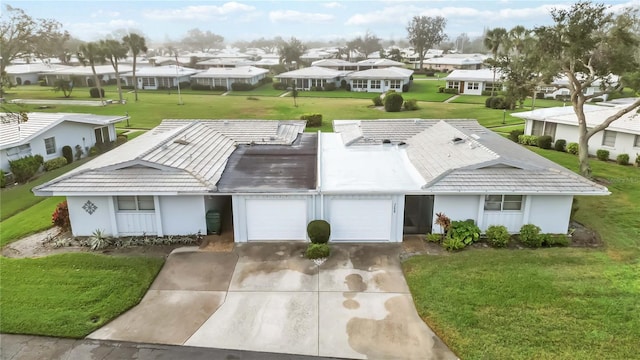 ranch-style home with a garage and a front lawn