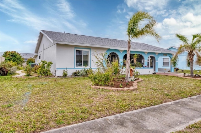 ranch-style house with a front lawn and stucco siding