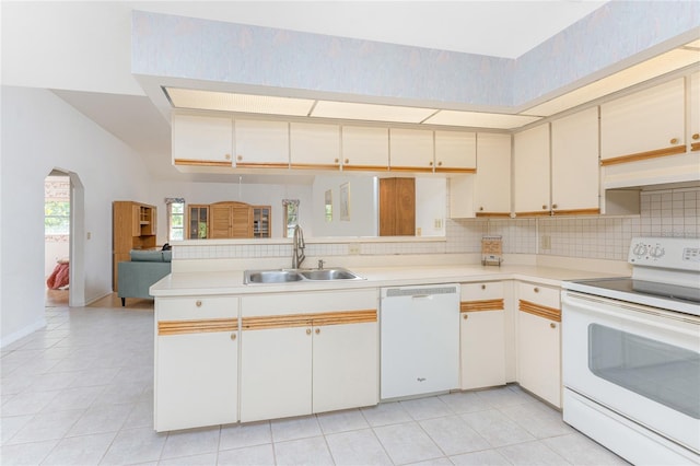 kitchen featuring custom exhaust hood, light tile patterned floors, a sink, light countertops, and white appliances