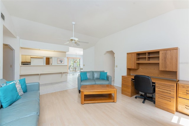 living area featuring light wood finished floors, visible vents, vaulted ceiling, and a ceiling fan