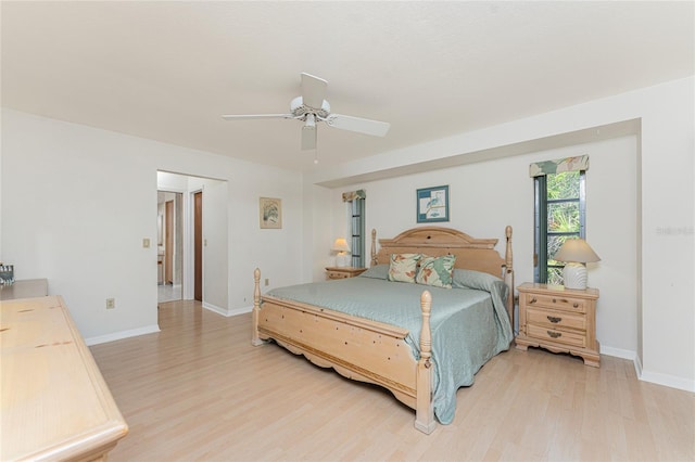 bedroom with baseboards, ceiling fan, and light wood-style floors