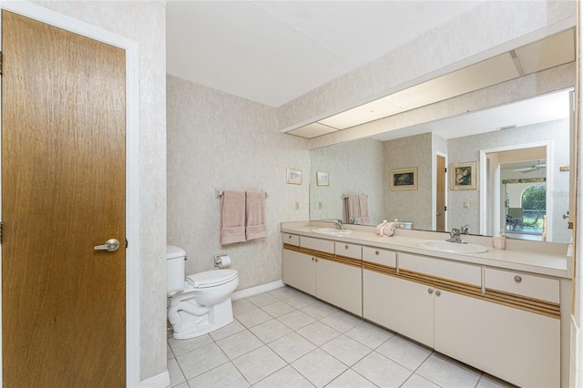 full bathroom featuring a sink, toilet, double vanity, and tile patterned flooring