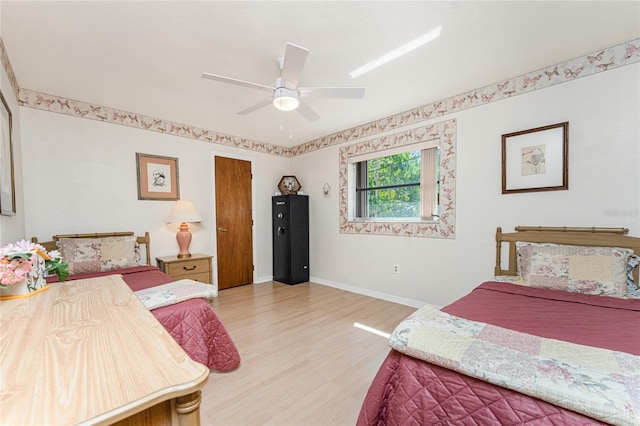bedroom with baseboards, ceiling fan, and light wood-style floors