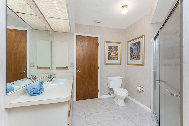 bathroom featuring a stall shower, vanity, visible vents, toilet, and tile patterned floors