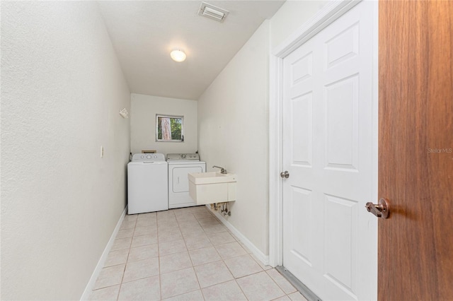 laundry area with laundry area, light tile patterned floors, visible vents, and washer and clothes dryer