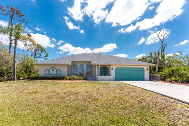 view of front of house featuring a front yard, an attached garage, driveway, and stucco siding