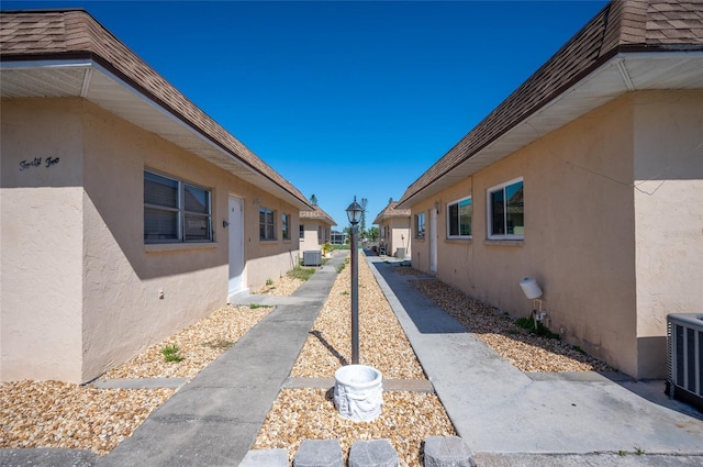 view of side of home with central air condition unit