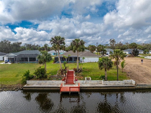 view of dock featuring a water view, a residential view, a lawn, and a lanai