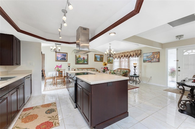 kitchen with stainless steel appliances, light countertops, an inviting chandelier, an island with sink, and island range hood