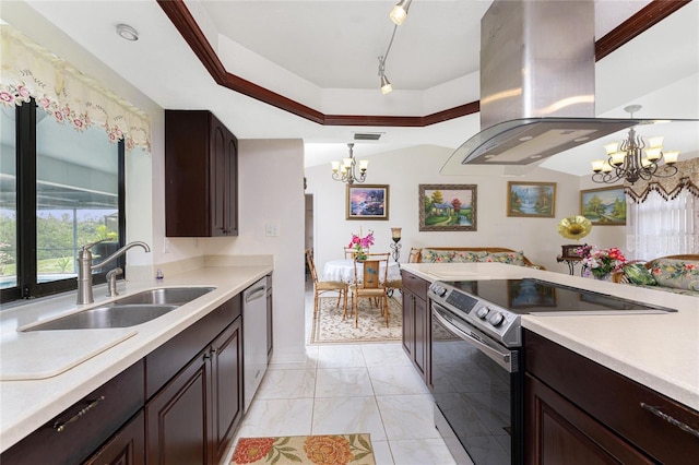 kitchen featuring stainless steel appliances, light countertops, a notable chandelier, and island range hood