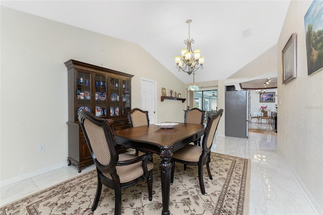 dining space featuring marble finish floor, baseboards, vaulted ceiling, and a chandelier