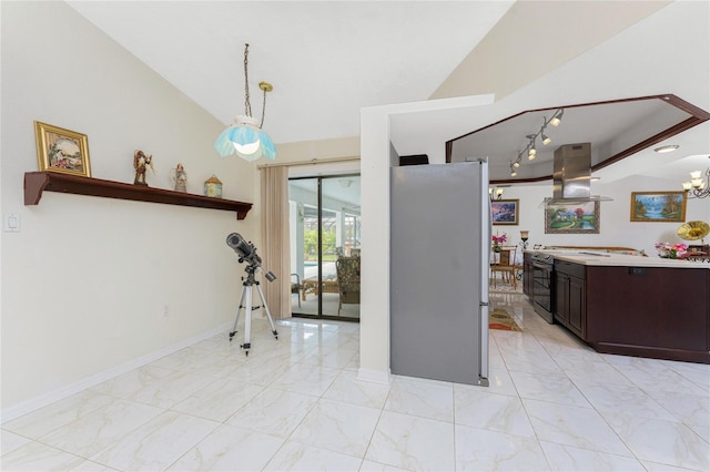 kitchen with marble finish floor, island exhaust hood, light countertops, appliances with stainless steel finishes, and vaulted ceiling