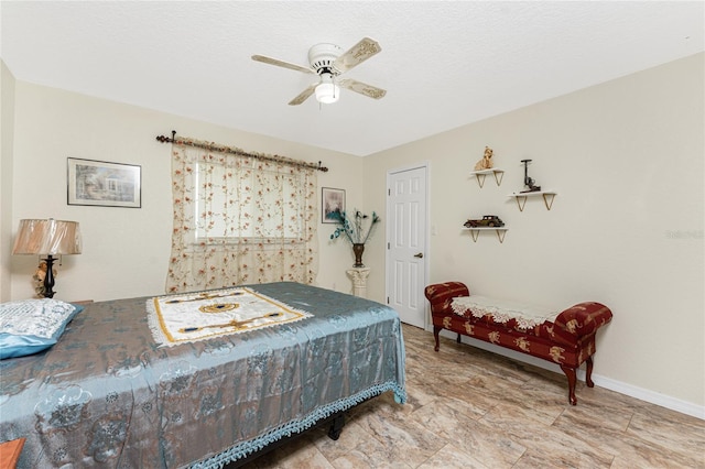 bedroom featuring a ceiling fan, a textured ceiling, and baseboards