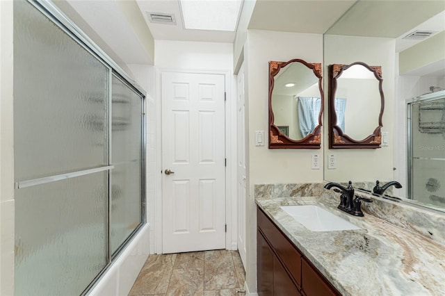 full bathroom featuring enclosed tub / shower combo, visible vents, and vanity