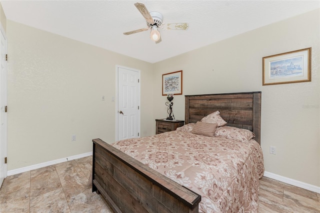 bedroom with ceiling fan and baseboards