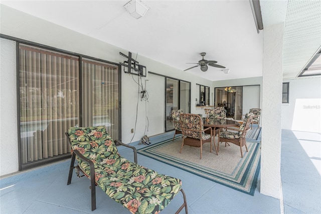 view of patio with a ceiling fan and outdoor dining area