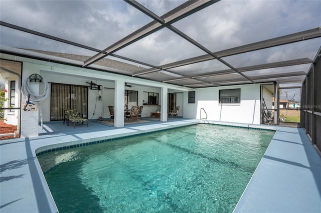 pool with a lanai, ceiling fan, and a patio