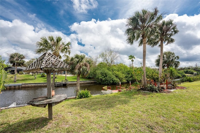 surrounding community with a yard and a water view