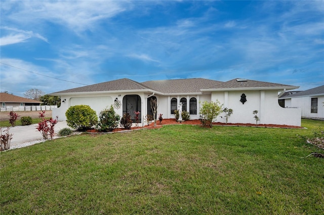 ranch-style home with an attached garage, stucco siding, concrete driveway, and a front yard