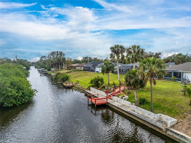 view of dock featuring a water view, a lanai, and a lawn