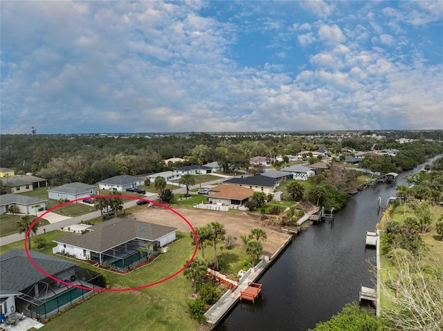 birds eye view of property featuring a water view and a residential view