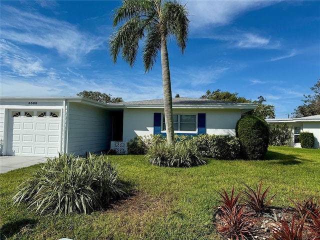 ranch-style home with a garage and a front lawn