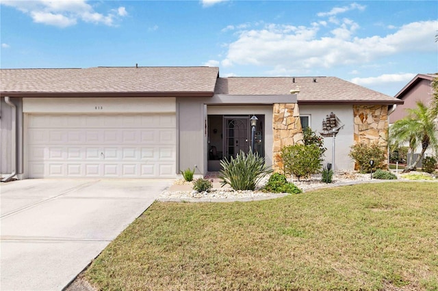 single story home with a garage, a shingled roof, concrete driveway, stone siding, and a front yard