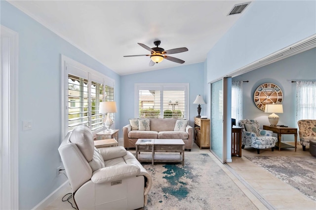 living area featuring vaulted ceiling, ceiling fan, visible vents, and a healthy amount of sunlight