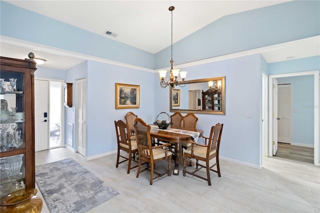 dining space with a chandelier, visible vents, vaulted ceiling, and baseboards