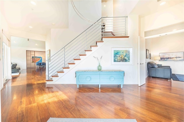 foyer entrance with a towering ceiling and hardwood / wood-style flooring