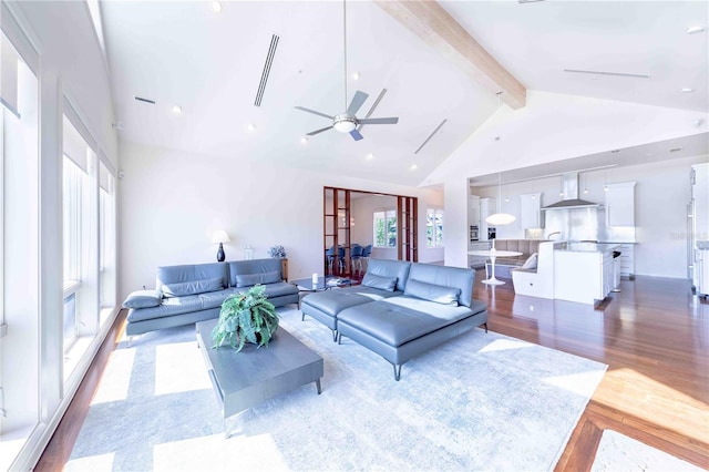 living room featuring beamed ceiling, ceiling fan, dark wood-type flooring, and high vaulted ceiling