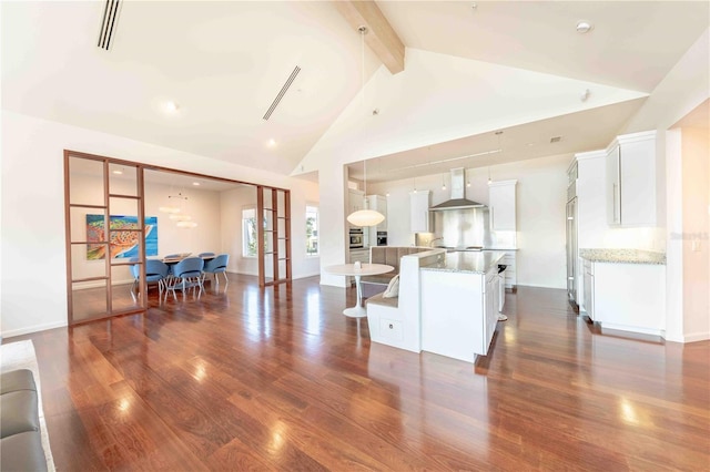 living room with high vaulted ceiling, dark hardwood / wood-style floors, and beamed ceiling