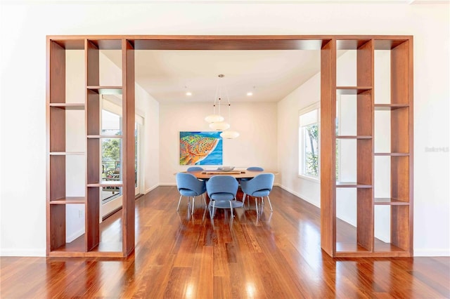 dining space with hardwood / wood-style floors