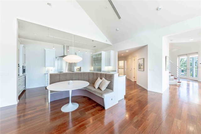 living room featuring dark hardwood / wood-style flooring and high vaulted ceiling