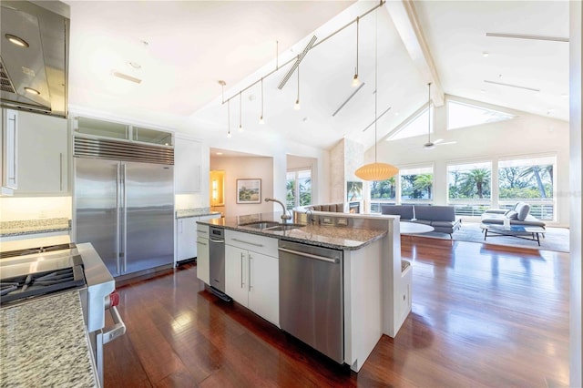 kitchen featuring hanging light fixtures, appliances with stainless steel finishes, sink, and white cabinets